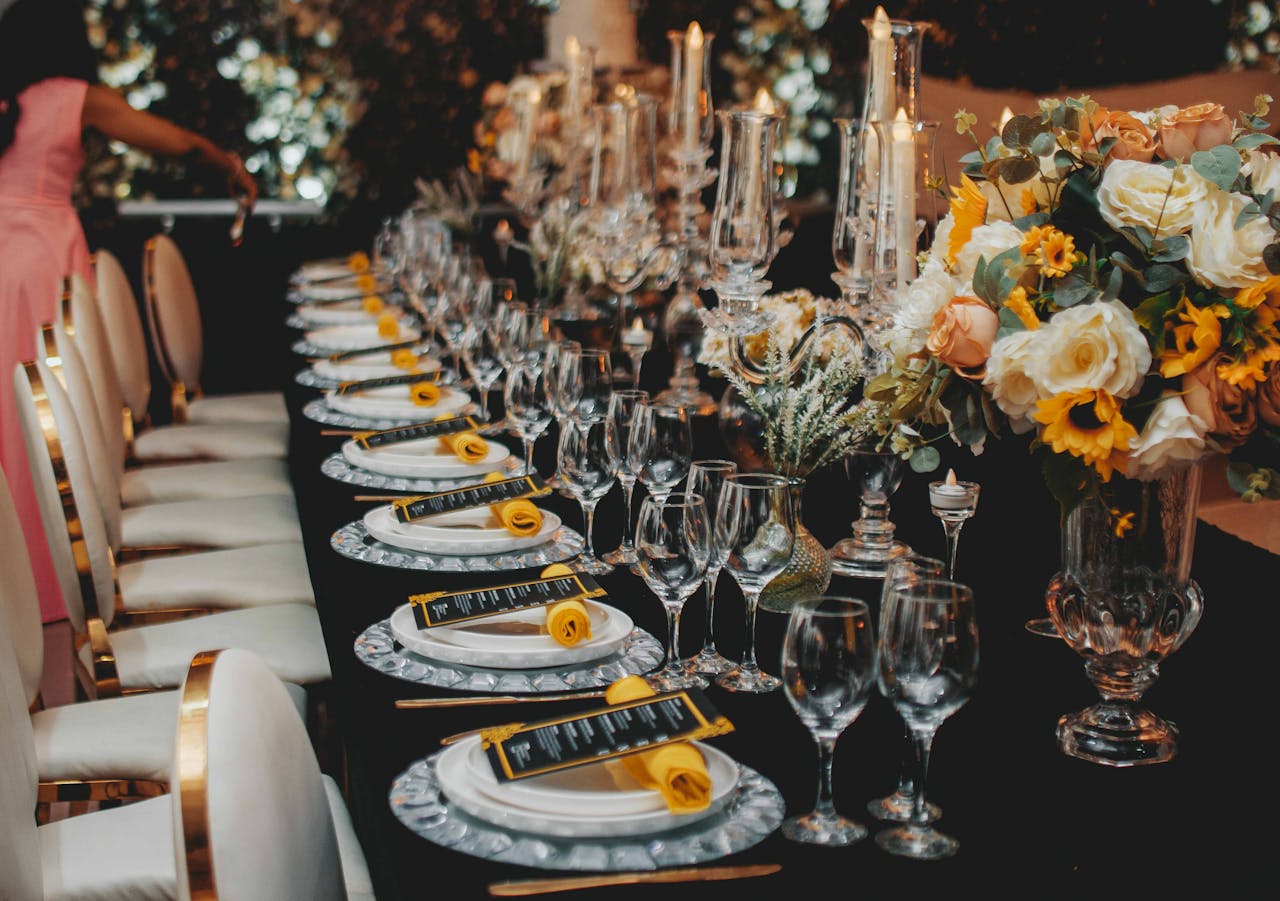 Luxurious dining table with floral centerpiece, elegant tableware, and decor for a special event.
