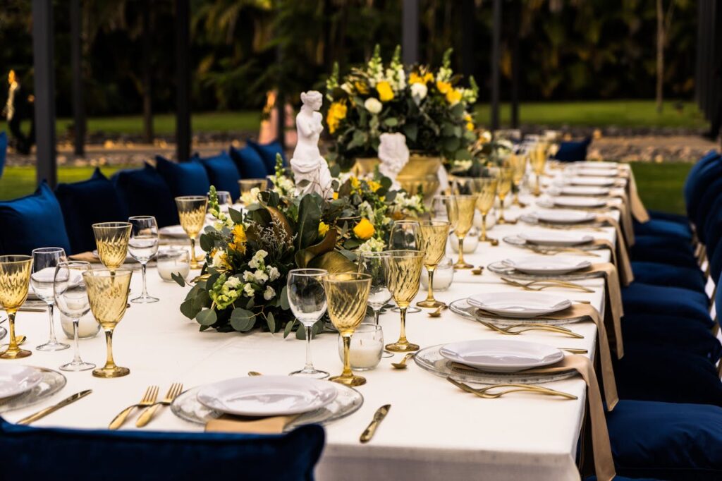 pexels photo 6162758 Luxurious outdoor dining setup with flowers and golden glassware for a sophisticated event.