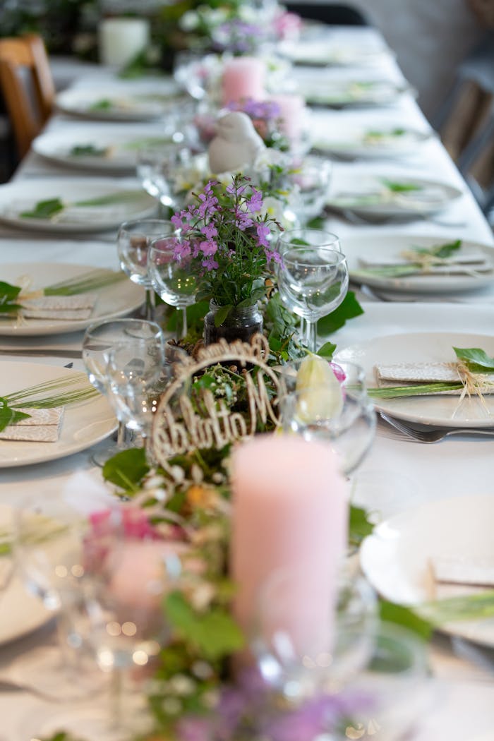 Beautifully arranged table setting with floral decorations and candles, perfect for events.